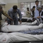 Pakistani Shiite Muslim mourners place t