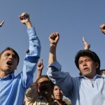 Ethnic Hazara Shi'ite men chant slogans during a demonstration outside hospital in Quetta