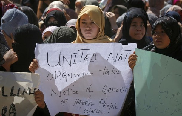 Ethnic Hazara Shi'ite women hold placards during a demonstration in Quetta