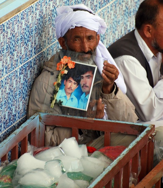 A Pakistani Shiite Muslim holds a pictur A Pakistani Shiite Muslim holds a pictur