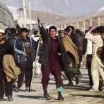 Afghan protesters gesture towards police in Kabul