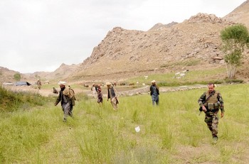 A French soldier walks with nomads