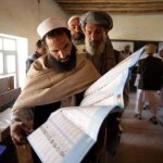 A Pashtun man looks up his desired candidate on the ballot as he queues to vote in Kabul. Saurabh Das / AP