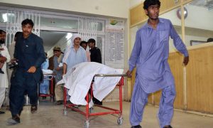 People at civil hospital shifting the bodies of those killed in the suicide blast near the Imambargah in Hazara town on Sunday. – Photo by Online