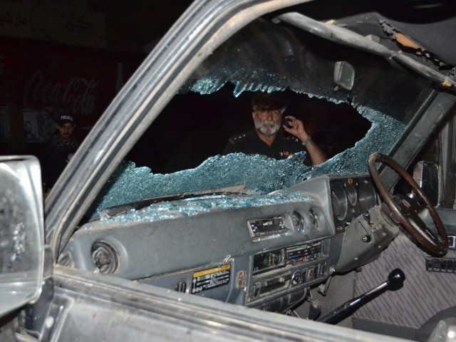 A Pakistani police officer looks at a bullet-riddled vehicle after an attack by gunmen in Quetta on July 15, 2013. PHOTO: AFP